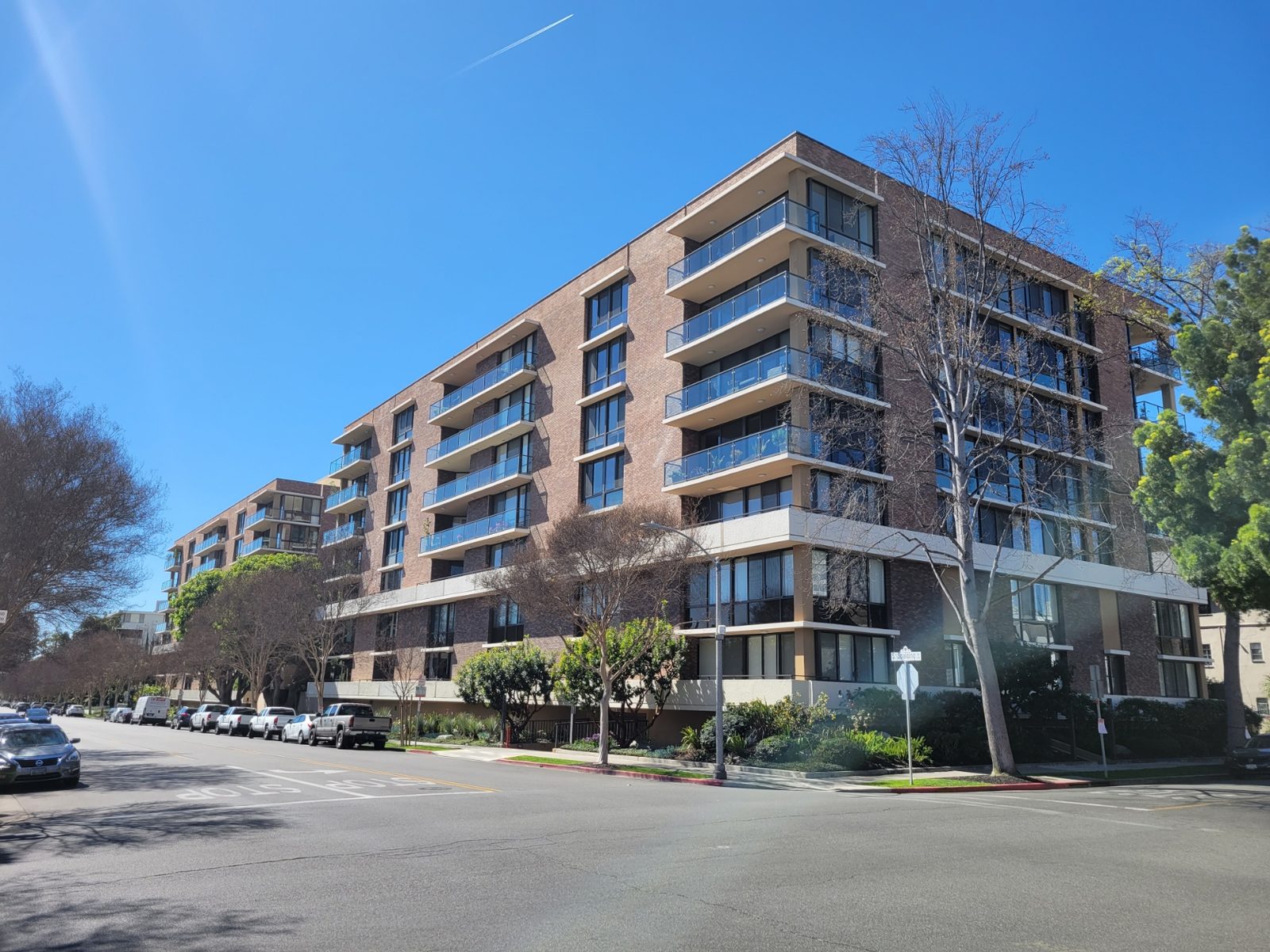 Two Eleven Spalding, a seven-story brick condominium building at 211 South Spalding Drive, Beverly Hills, on a clear day